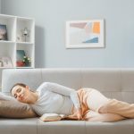 young-beautiful-woman-home-clothes-sleeping-couch-home-interior-with-book-spending-weekend-home_141793-131369